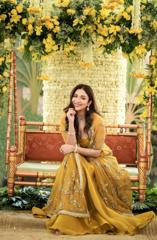 Mustard yellow skirt and draped top set with heavily embellished cape