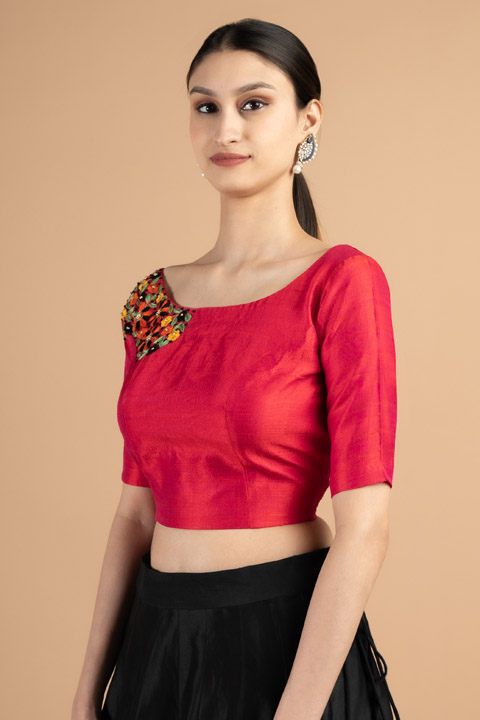 Red blouse with colorful embroidery on one shoulder side