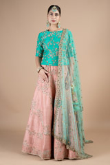 Marine green waist length blouse paired with peach lehenga set