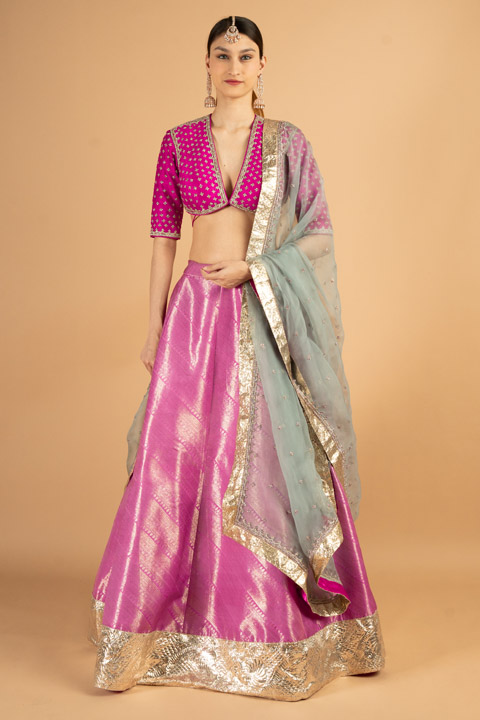 Rani pink embroidered blouse with woven silk lehenga and grey organza dupatta